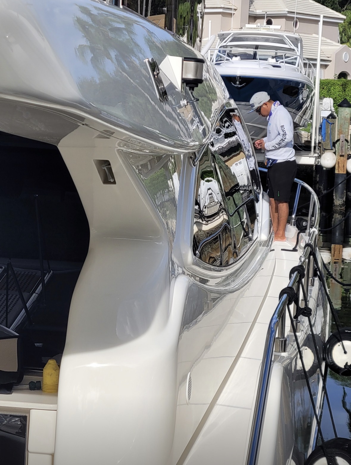 A man on a boat inspects and cleans the vessel, ensuring it is in good condition for use.